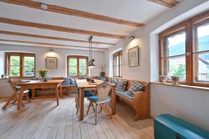 a living room with a table and a couch at Exklusives und Modernes Bauernhaus in Nesselwang