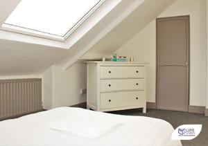 a bedroom with a white bed and a skylight at Luke Stays - Brighton Road in Gateshead