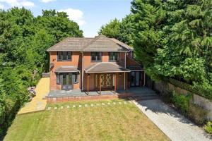 an aerial view of a brick house with a yard at Hampshire gated home in exclusive location in Southampton