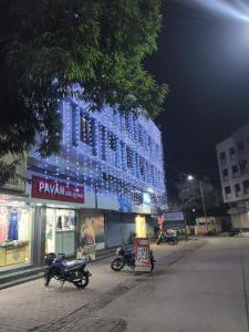 a building with blue lights on the side of it at Sai Anand in Nashik
