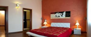 a red bedroom with a bed and two lamps at Villa Taranta in Racale +13 photos