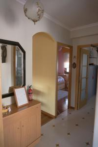 a room with a table and a mirror and a hallway at Apartamento con piscina privada in Vigo