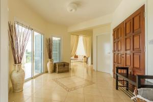 a living room with a large wooden door and a couch at Villa Riverside in Polis Chrysochous