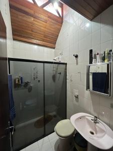 a bathroom with a shower and a toilet and a sink at Sobrado Bairro Alto in Curitiba