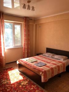 um quarto com uma cama e uma janela em Adilet Fatima em Bishkek