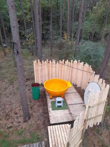 a wooden deck with a bath tub and a wooden fence at White Box in Gierle