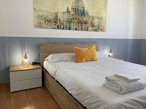 a bedroom with a bed with towels on it at B&S Home Vaticano in Rome