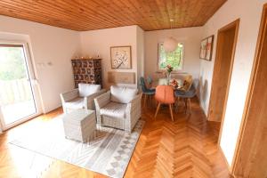 a living room with a table and chairs at Holiday Home Liberg with Hot tub and Sauna in Brežice