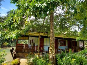 a house with a porch and a tree at Ao Jark Homestay in Ban Bang Bao