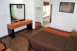 a bathroom with a bed and a sink and a mirror at Hotel Castro in Mexico City
