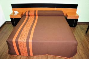 a bed in a room with two night stands at Hotel Castro in Mexico City +2 photos