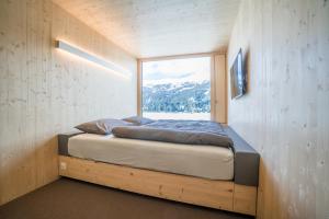 Voodi või voodid majutusasutuse Revier Mountain Lodge Lenzerheide toas