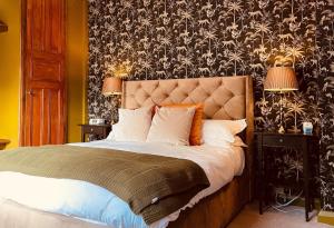 a bedroom with a bed with a black and white wallpaper at The Old Registry guest house in Haworth
