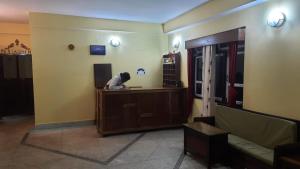 a woman sitting at a desk in a room at Hotel Pemathang in Pemayangtse