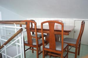 a dining room table with two chairs and a table at Arcanjo Hostel 2 in Braga