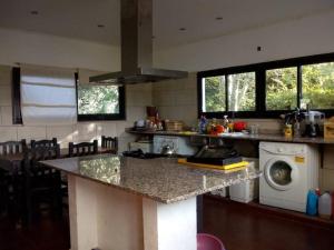 a kitchen with a counter and a washing machine at Casa quinta en Mercedes, Bs As in Mercedes