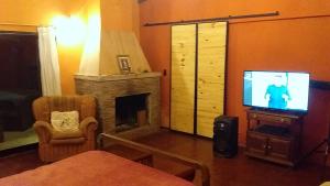 a living room with a tv and a fireplace at Casa quinta en Mercedes, Bs As in Mercedes