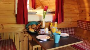 a table with food and drinks in a cabin at AZUR Camping Regensburg in Regensburg