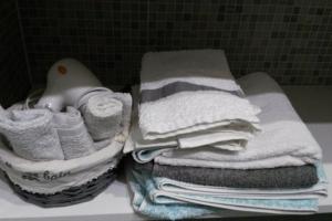 a pile of towels on a counter in a bathroom at I Balconi sul Duomo in Lecce