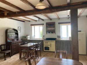 a kitchen with wooden tables and chairs in a room at Rustic cottage with stunning swimming pool in Saint-Front