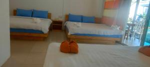 a room with two beds with blue pillows at Sweet Time Bungalows in Koh Rong Sanloem
