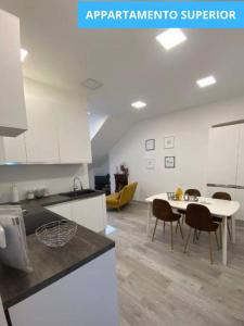 a kitchen with a table and chairs in a room at MansardaTO - La Tua casa nel cuore di Torino in Turin