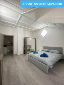 a bedroom with a bed with blue pillows on it at MansardaTO - La Tua casa nel cuore di Torino in Turin