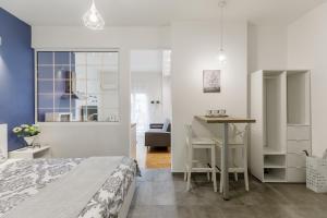 a bedroom with a bed and a desk and a table at NAVA Apartment in the center of Thessaloniki in Thessaloniki