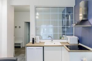 a kitchen with a sink and a window at NAVA Apartment in the center with private parking of stayinthess in Thessaloniki +39 photos