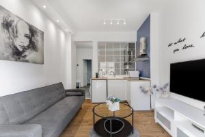 a living room with a couch and a kitchen at NAVA Apartment in the center of Thessaloniki in Thessaloniki