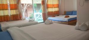 a bedroom with two beds and a window at Sweet Time Bungalows in Koh Rong Sanloem