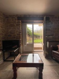 ein Wohnzimmer mit einem Kamin und einem Couchtisch in der Unterkunft Apartamento en Cantabria, Treceño in Treceño