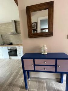 a blue dresser in a kitchen with a mirror at Apartamento en Cantabria, Treceño in Treceño
