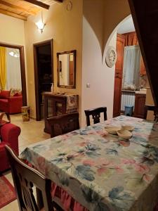 a dining room with a table with a floral table cloth at Alloggio Turistico Katy in Celleno