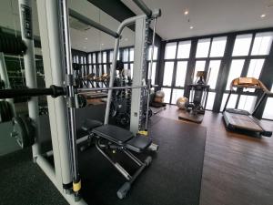 a gym with a bunch of equipment in a building at Pavilion 2 Revo l Rooftop Swimming Pool LS15 in Kuala Lumpur