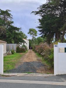 a dirt road with a white appliance in a driveway at LES EMBRUNS in La Tranche-sur-Mer