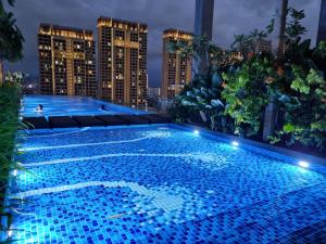 a swimming pool on the roof of a building at night at Pavilion 2 Revo l Rooftop Swimming Pool LS15 in Kuala Lumpur +15 photos