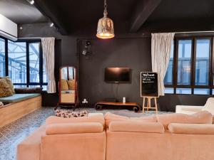 a living room with a couch and a tv at Clocktower Homestay 2 to 8 pax at Brinchang, Cameron Highlands in Cameron Highlands