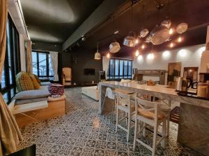 a kitchen and living room with a table and chairs at Clocktower Homestay 2 to 8 pax at Brinchang, Cameron Highlands in Cameron Highlands