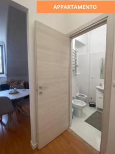 an open door to a bathroom with a toilet at MansardaTO - La Tua casa nel cuore di Torino in Turin