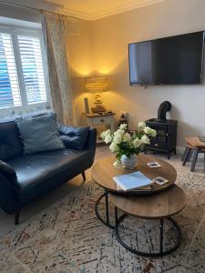 a living room with a couch and a table at Wogan Cottage in Saundersfoot