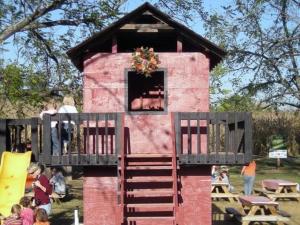 a small pink play house with a window and stairs at Tentrr Signature Site - Sunflower Ridge at The Stickley Farm in Bluff City