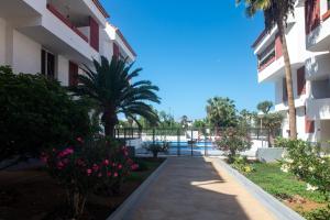 a walkway leading to the pool at a resort at Casa Sami in Playa de las Americas +60 photos