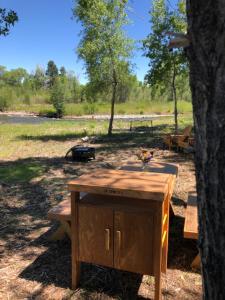 a picnic table under a tree in a park at Tentrr Signature Site - Los Pinos River Camp in Bayfield