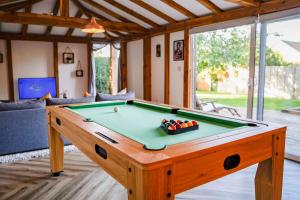 a pool table in the middle of a living room at The Cabin in Fareham