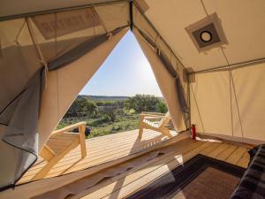 an inside view of a tent with a wooden deck at Tentrr Signature Site - Texas 1873 in May