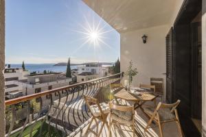 a balcony with a table and chairs and a view of the ocean at Soul house POLA in Split