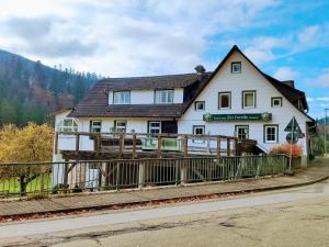 a white house with a fence in front of it at Pension Forelle in Forbach
