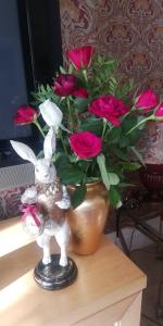a statue of a bunny next to a vase of roses at Northdene Theatre Hotel in Blackpool