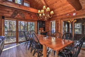 a dining room with a wooden table and chairs at Cranberry Cove Lodge in Eagle River